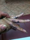 text tattoo on fingers